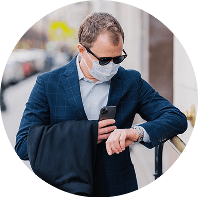 Person with a face mask looking at the watch